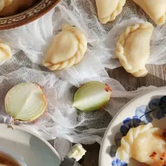 Gotowe pierogi ruskie, cebula i masło. Idealne na obiad, zgodnie z przepisem na pierogi ruskie.