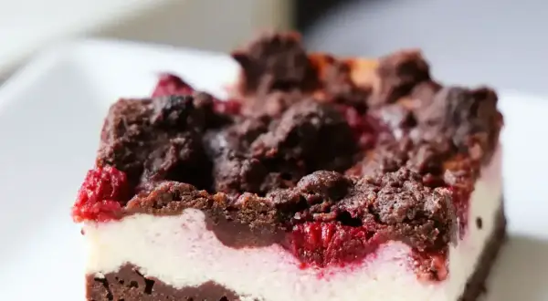 Pyszny sernikobrownie z malinami, z czekoladową kruszonką i kremowym serkiem. Idealny deser dla każdego łasucha.