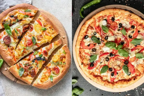 Pyszna pinsa z pomidorkami, papryką i ziołami, obok klasyczna pizza z oliwkami i serem.