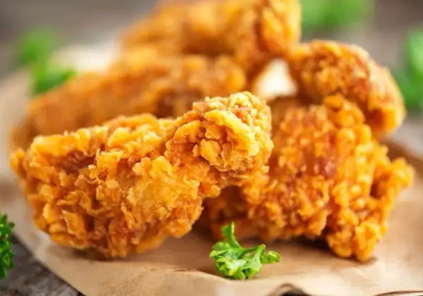 Chrupiące skrzydełka jak z KFC, złociste i apetyczne, podane na papierze.